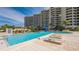 Inviting resort-style pool with lounge chairs at 1211 Gulf Of Mexico Dr # 603, Longboat Key, FL 34228