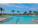 Relaxing pool area with palm trees and ample seating at 1211 Gulf Of Mexico Dr # 603, Longboat Key, FL 34228