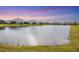 Community pond with houses and lush landscaping around it at 12810 Seasong Ter, Bradenton, FL 34211