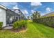 Landscaped backyard with a screened porch at 12810 Seasong Ter, Bradenton, FL 34211