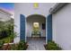 Quaint entryway features a blue bench and arched entryway at 12810 Seasong Ter, Bradenton, FL 34211