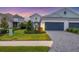 Two-story home with a three-car garage and landscaped front yard at 12810 Seasong Ter, Bradenton, FL 34211