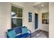 Inviting front porch with blue bench and patterned pillows at 12810 Seasong Ter, Bradenton, FL 34211