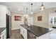 Island kitchen with dark countertops and stainless steel appliances at 12810 Seasong Ter, Bradenton, FL 34211