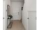 Bright and spacious entryway with tile flooring and a modern console table at 15052 Cuzcorro Ct, Nokomis, FL 34275