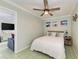 Bright bedroom with a queen-size bed and ceiling fan at 1603 Gulf N Dr # 24, Bradenton Beach, FL 34217