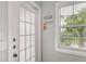 Bright and airy entryway with a glass door and beachy decor at 1603 Gulf N Dr # 24, Bradenton Beach, FL 34217