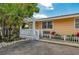 Inviting exterior with a charming porch and well-maintained landscaping at 1603 Gulf N Dr # 24, Bradenton Beach, FL 34217