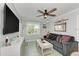 Cozy living room features a sofa, TV, and coastal decor at 1603 Gulf N Dr # 24, Bradenton Beach, FL 34217
