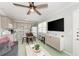 Comfortable living room with a sofa, TV, and adjacent kitchen at 1603 Gulf N Dr # 24, Bradenton Beach, FL 34217
