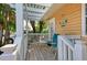 Relaxing porch with pergola, seating, and tropical views at 1603 Gulf N Dr # 24, Bradenton Beach, FL 34217