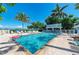 Community pool with lounge chairs and waterfront views at 1603 Gulf N Dr # 24, Bradenton Beach, FL 34217