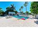Relaxing community pool with pergola and lounge chairs at 1603 Gulf N Dr # 24, Bradenton Beach, FL 34217