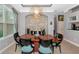 Formal dining room with stone accent wall and modern chandelier at 16806 5Th Ne Ter, Bradenton, FL 34212