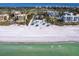 Aerial view of community beach area showing picnic cabanas, surrounding community, and blue ocean waters at 1906 Harbour Links Cir # 14, Longboat Key, FL 34228