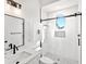 Modern bathroom with walk-in shower, white tile, and updated vanity at 1906 Harbour Links Cir # 14, Longboat Key, FL 34228