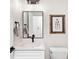 Modern bathroom with white vanity, quartz countertop, and black fixtures at 1906 Harbour Links Cir # 14, Longboat Key, FL 34228