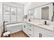 Spa-like bathroom with double vanity, soaking tub, and walk-in shower at 1906 Harbour Links Cir # 14, Longboat Key, FL 34228