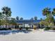 View of beach access from the parking lot, showcasing palm trees, landscaping, and the beautiful ocean at 1906 Harbour Links Cir # 14, Longboat Key, FL 34228