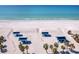Beach view of the picnic cabana area on a sunny day; shows blue ocean waters and white sand at 1906 Harbour Links Cir # 14, Longboat Key, FL 34228