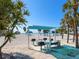 Sunny day beach view showing grills and cabana in picnic area, perfect for outdoor cooking and gatherings at 1906 Harbour Links Cir # 14, Longboat Key, FL 34228