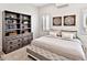 Serene bedroom with a king bed, built-in shelving, and window seating at 1906 Harbour Links Cir # 14, Longboat Key, FL 34228