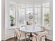 Bright breakfast nook with a round table and four chairs, overlooking the backyard at 1906 Harbour Links Cir # 14, Longboat Key, FL 34228