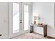 Bright entryway with double doors and a stylish console table at 1906 Harbour Links Cir # 14, Longboat Key, FL 34228