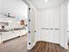 Bright hallway with white built-in storage and hardwood floors at 1906 Harbour Links Cir # 14, Longboat Key, FL 34228