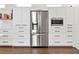 Modern kitchen with built in stainless steel refrigerator at 1906 Harbour Links Cir # 14, Longboat Key, FL 34228