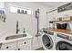 Laundry room with washer, dryer, and additional storage at 1906 Harbour Links Cir # 14, Longboat Key, FL 34228