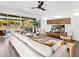 Open concept living room with modern decor, wood floors, and pool view at 1906 Harbour Links Cir # 14, Longboat Key, FL 34228