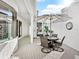 Relaxing patio with seating area and an umbrella for shade at 1906 Harbour Links Cir # 14, Longboat Key, FL 34228