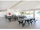 Interior shot of the beach access area with multiple picnic tables and views of palm trees and beach at 1906 Harbour Links Cir # 14, Longboat Key, FL 34228