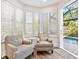 Relaxing sitting area with two armchairs and access to the pool area at 1906 Harbour Links Cir # 14, Longboat Key, FL 34228