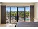 Bedroom with balcony access and pool view at 204 3Rd W St # 203, Bradenton, FL 34205