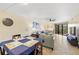 Spacious living room with light tile floors, comfortable seating, and balcony access at 204 3Rd W St # 203, Bradenton, FL 34205