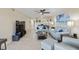 Open living room with light-colored sofas and a large TV at 204 3Rd W St # 203, Bradenton, FL 34205