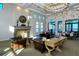 Elegant lounge area with fireplace and lake view at 204 Villoresi Blvd, Nokomis, FL 34275