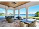 Covered patio overlooking a lake with wicker furniture at 204 Villoresi Blvd, Nokomis, FL 34275
