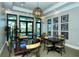 Community room with tables, chairs, and large windows at 204 Villoresi Blvd, Nokomis, FL 34275