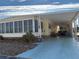 Yellow mobile home with carport and covered patio at 2107 Palma Sola Blvd # 27, Bradenton, FL 34209