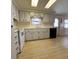 Bright kitchen with white cabinets and light flooring at 2107 Palma Sola Blvd # 27, Bradenton, FL 34209
