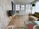 Sunroom with a TV, seating area, and wood-look floors at 2107 Palma Sola Blvd # 27, Bradenton, FL 34209