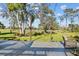 Relaxing back patio with seating area, string lights, and scenic golf course view at 2305 Little Country Rd, Parrish, FL 34219