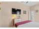 Bedroom with large TV, dresser, and access to a bathroom at 2305 Little Country Rd, Parrish, FL 34219