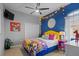 Vibrant bedroom with yellow headboard, colorful bedding, and fun decor at 2305 Little Country Rd, Parrish, FL 34219