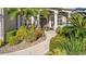 Front entry with walkway, landscaping, and double doors at 2305 Little Country Rd, Parrish, FL 34219