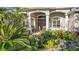 Front entry with lush landscaping and double doors at 2305 Little Country Rd, Parrish, FL 34219