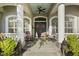 Inviting front porch with rocking chairs and double front doors at 2305 Little Country Rd, Parrish, FL 34219